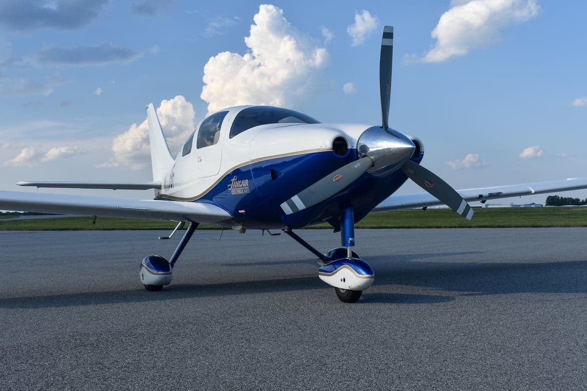 Lancair Columbia 350 aircraft, registration N350SF, parked on the tarmac.