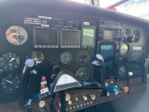 Close-up of the instrument panel in a Cessna 185 Skywagon, showing the avionics and flight controls.