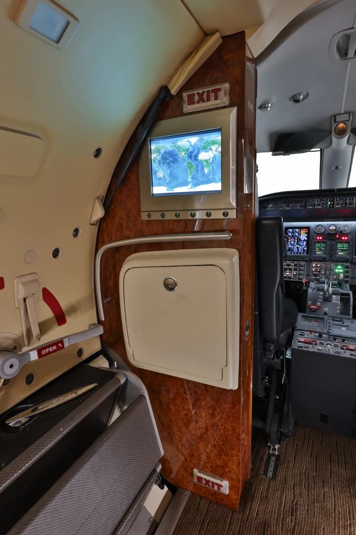 View of the cockpit and a monitor displaying a world map.