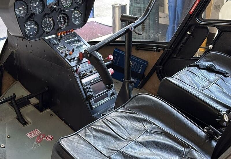 View of the cockpit and front seats of a Robinson R44 helicopter.