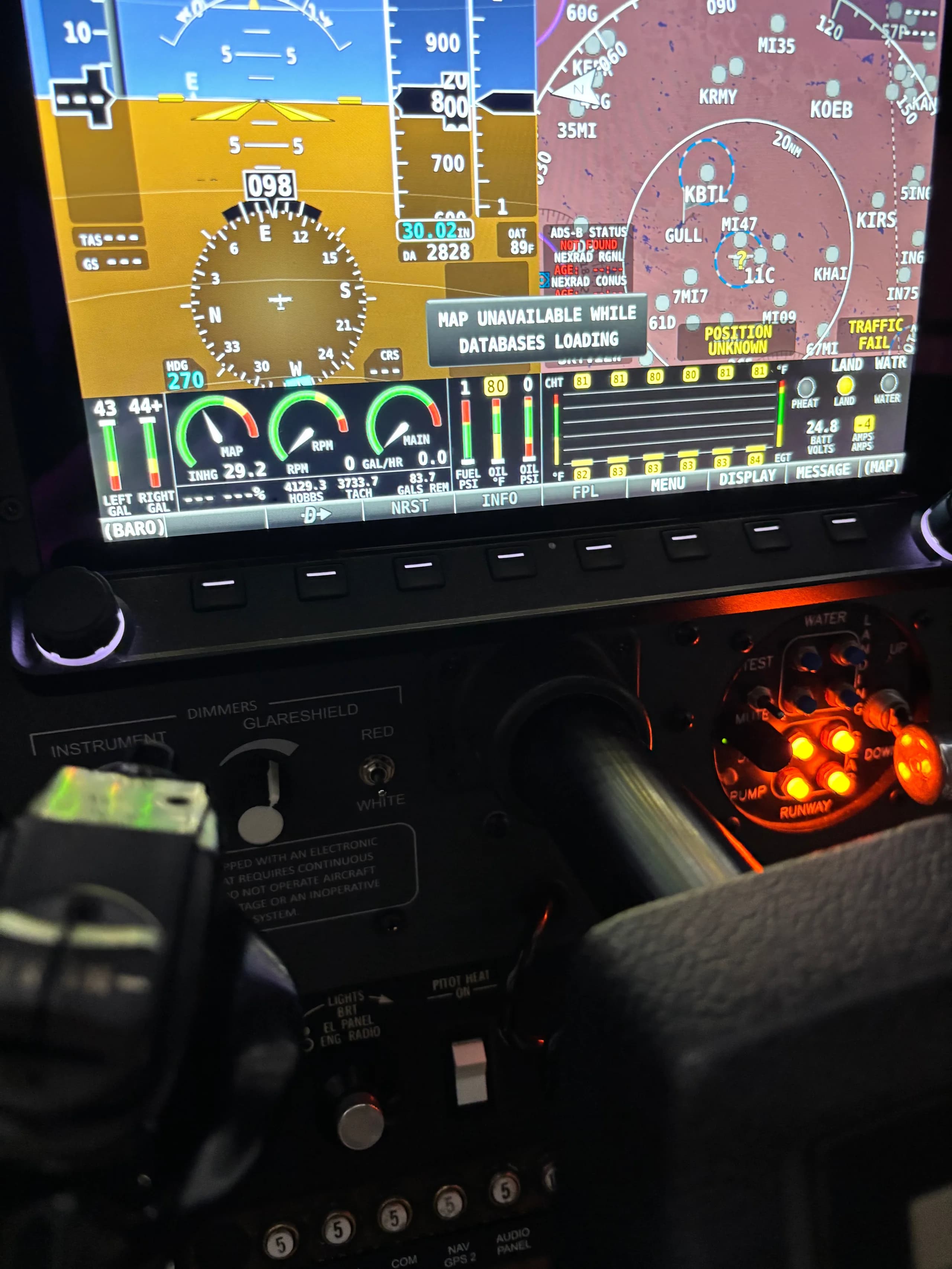 A detailed view of an aircraft's instrument panel with illuminated gauges and controls.