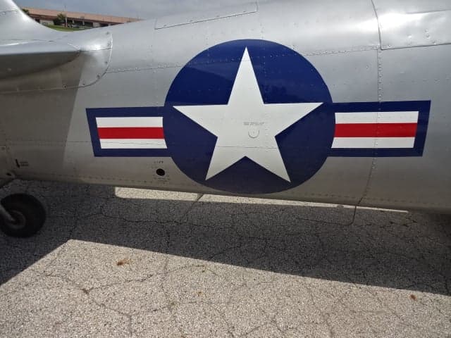 Close-up of the US Air Force star on the side of the silver T-6 Texan aircraft.