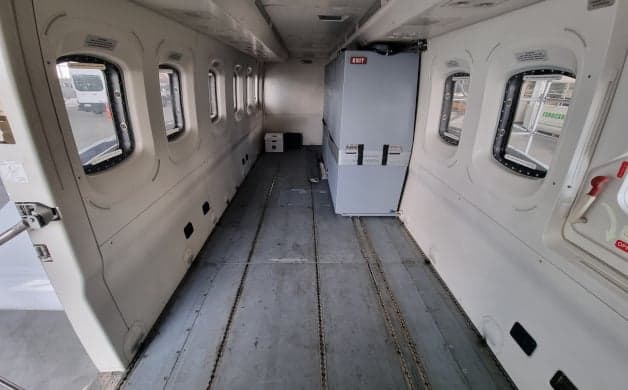 The interior of a helicopter with an open cargo area.