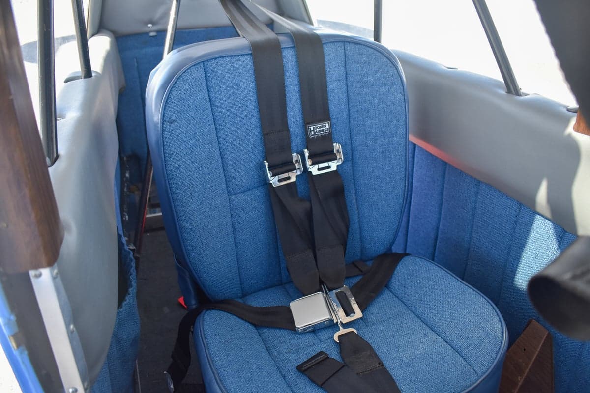 View of the blue fabric seats and interior of the aircraft.