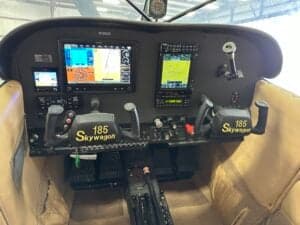 The cockpit of a Cessna 185 Skywagon features modern avionics and controls.