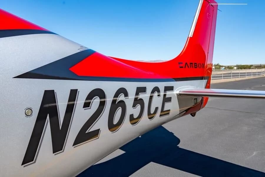 A close-up view of the tail section of the aircraft, showing registration N265CE and "CARBON" branding.