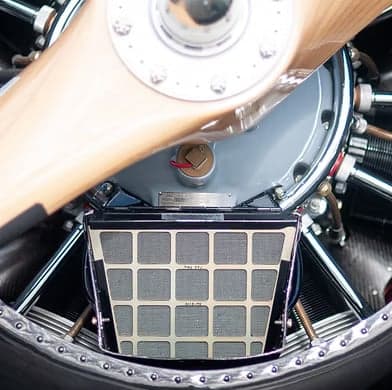 Close up of the engine and propeller of a biplane.