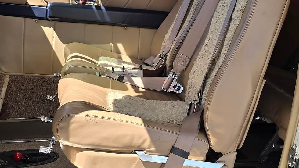 Close-up of a seat inside the Cessna 207A Turbo Stationair 800, showing the seatbelt and sheepskin cover.