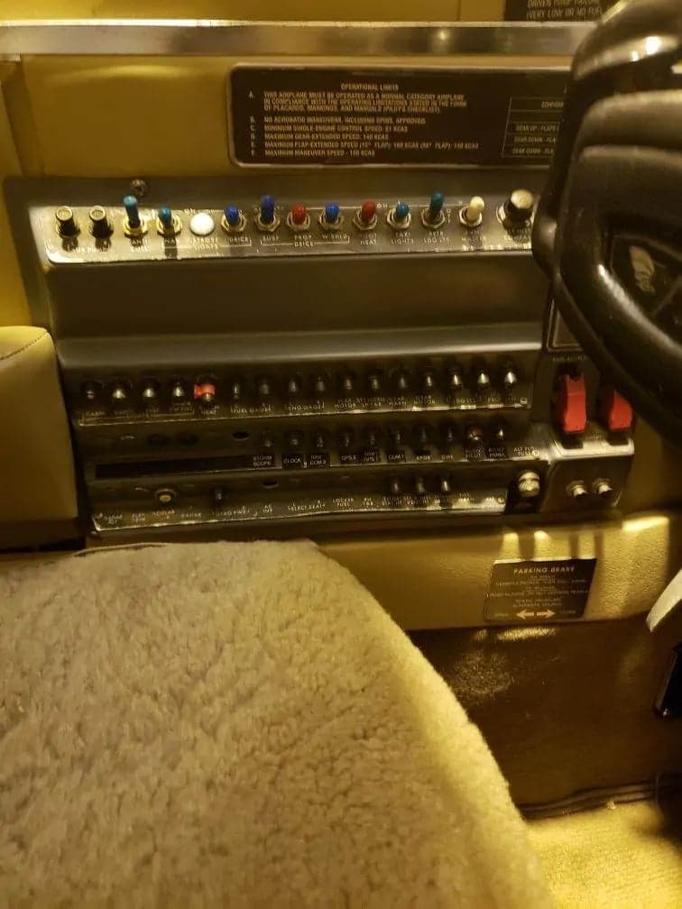 Close-up of the aircraft's switch panel and operational limits placard.