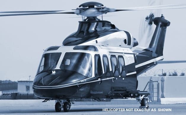 A black and silver helicopter on the ground.