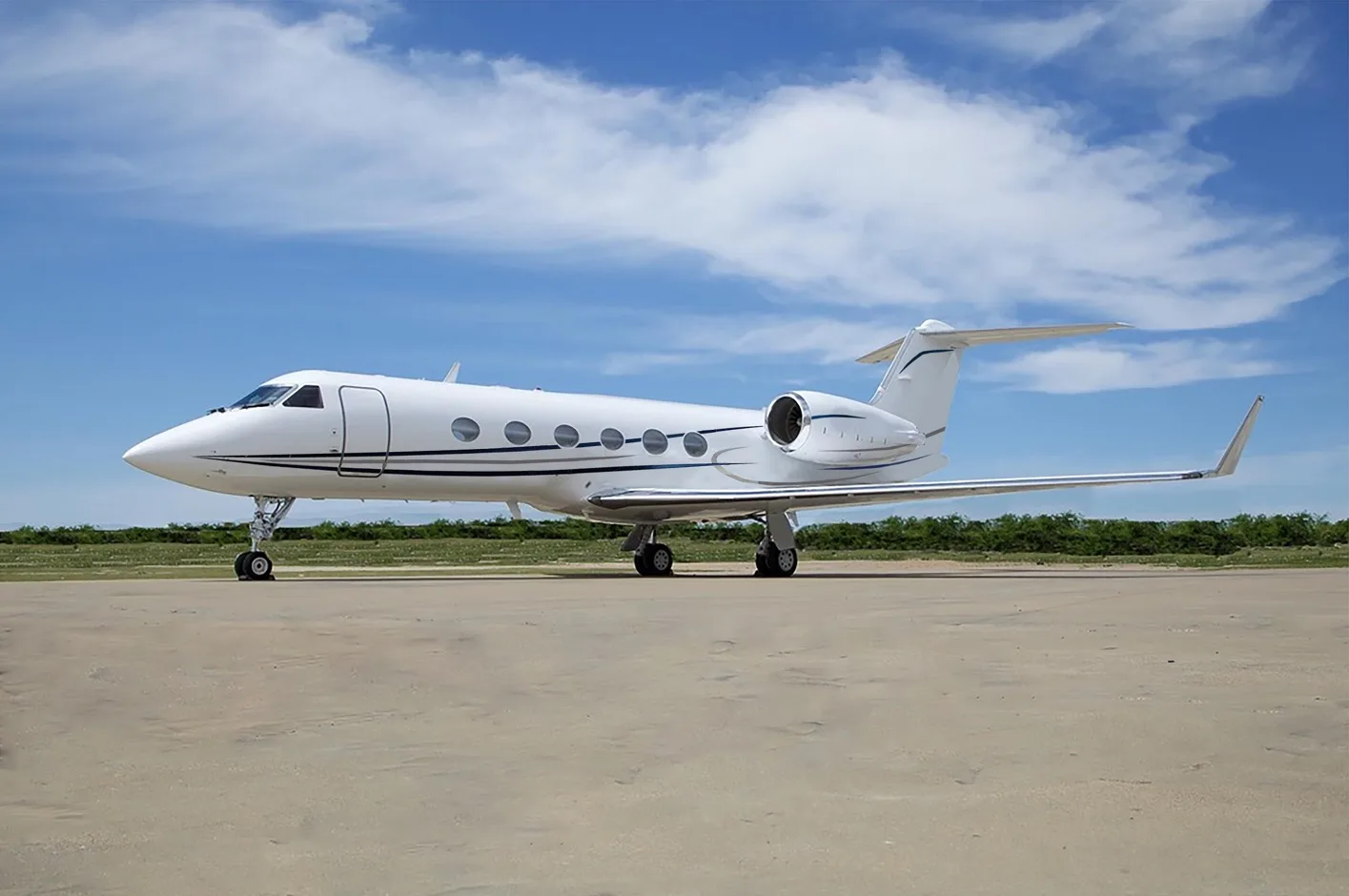 Gulfstream jet parked on the tarmac on a sunny day.