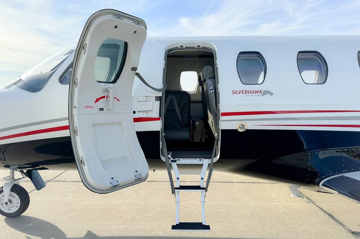 Close-up of the open door and steps of a Cessna Citation CJ3+ aircraft, showing the Silverhawk Aviation logo.
