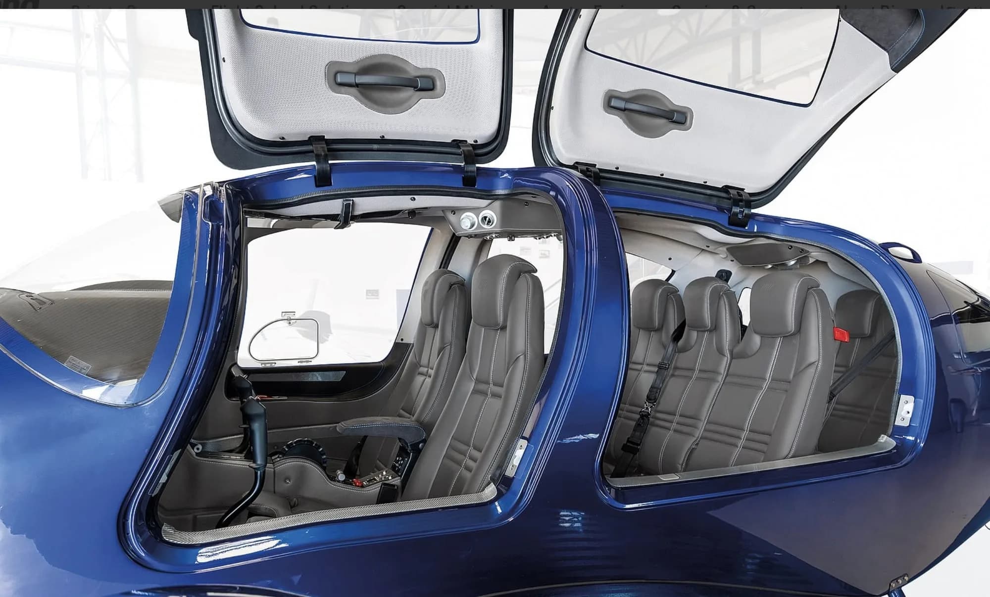 Interior view of a Diamond DA62 aircraft with seats and open doors.