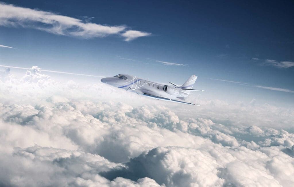 A light jet flying above the clouds.