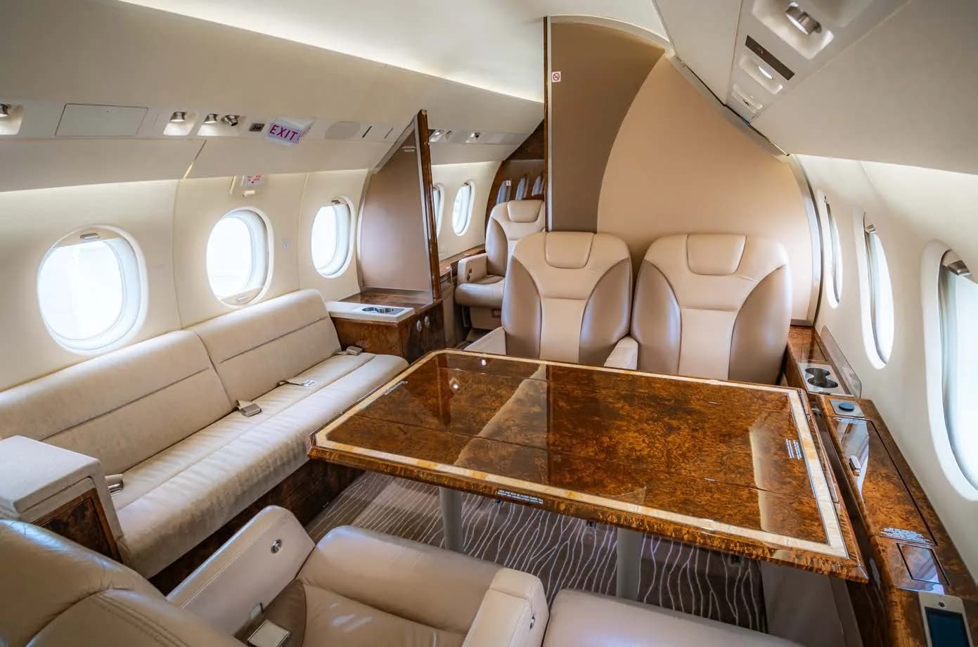 Interior view of the aircraft cabin with a table and sofa.
