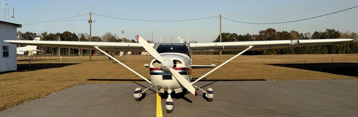 Front view of the Cessna 210 Centurion N71002, with its propeller and landing gear visible.