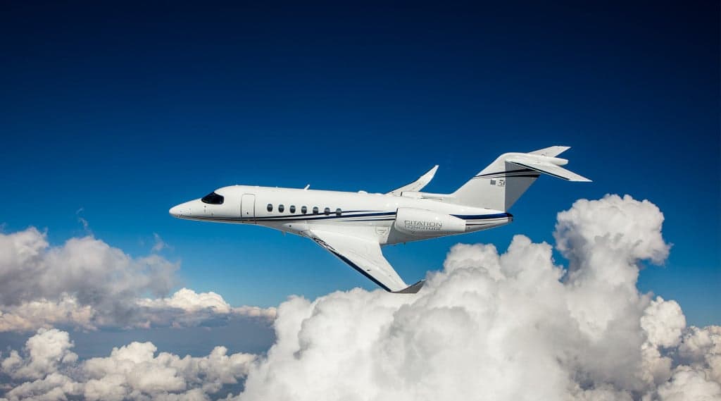 A Citation Sovereign flying above the clouds.