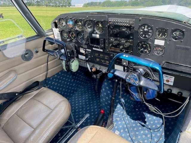 View of the cockpit with instrument panel and seats.