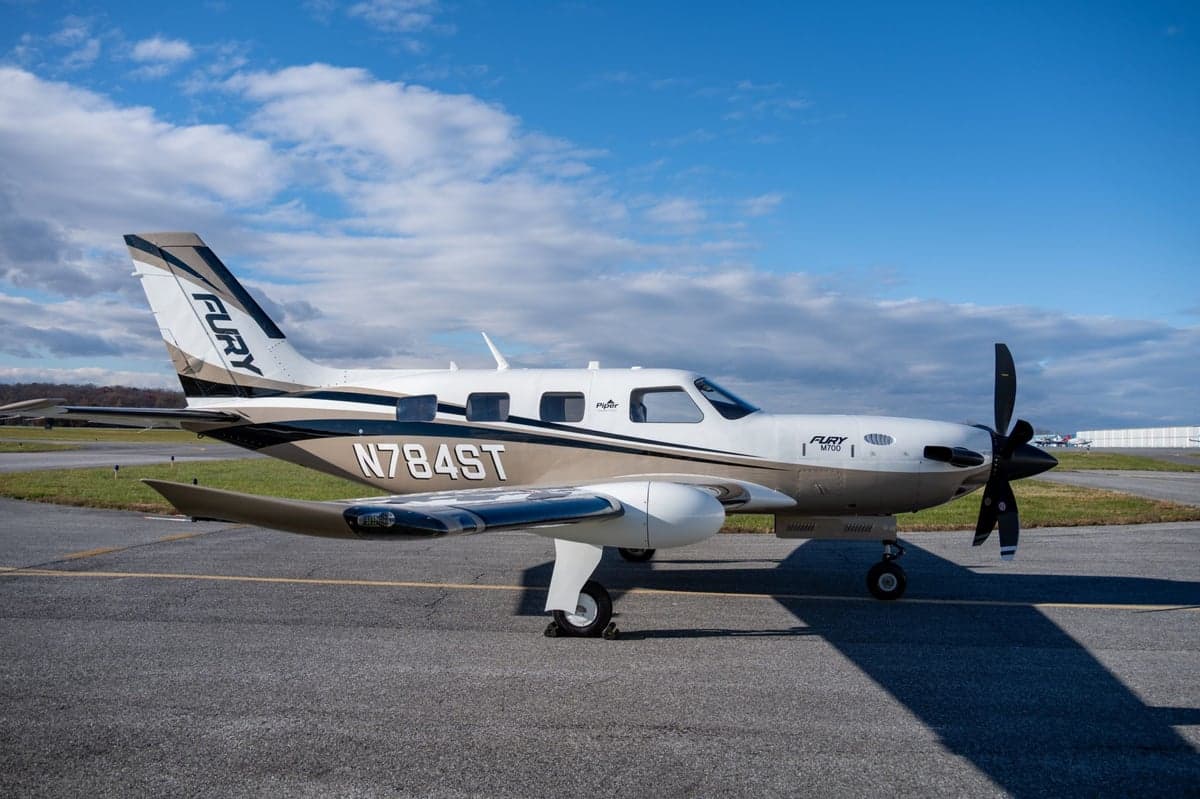 Side view of the Fury M700 aircraft with tail number N784ST on the tarmac.