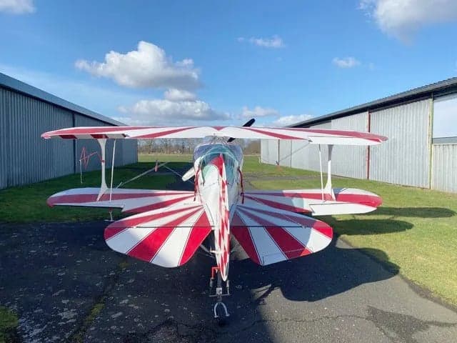 Red seat with harness inside the biplane.