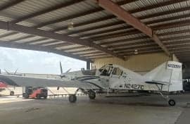 An Air Tractor crop duster sits in a hangar.
