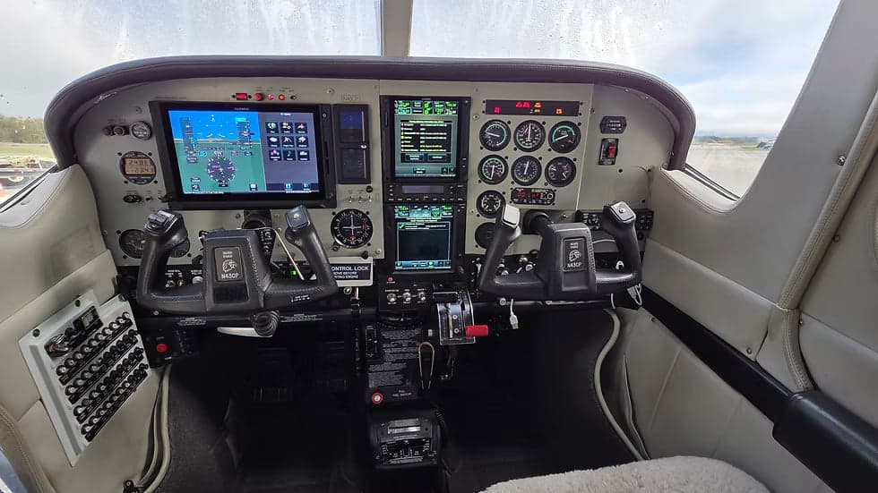 The cockpit of the aircraft, featuring the instrument panel and controls.