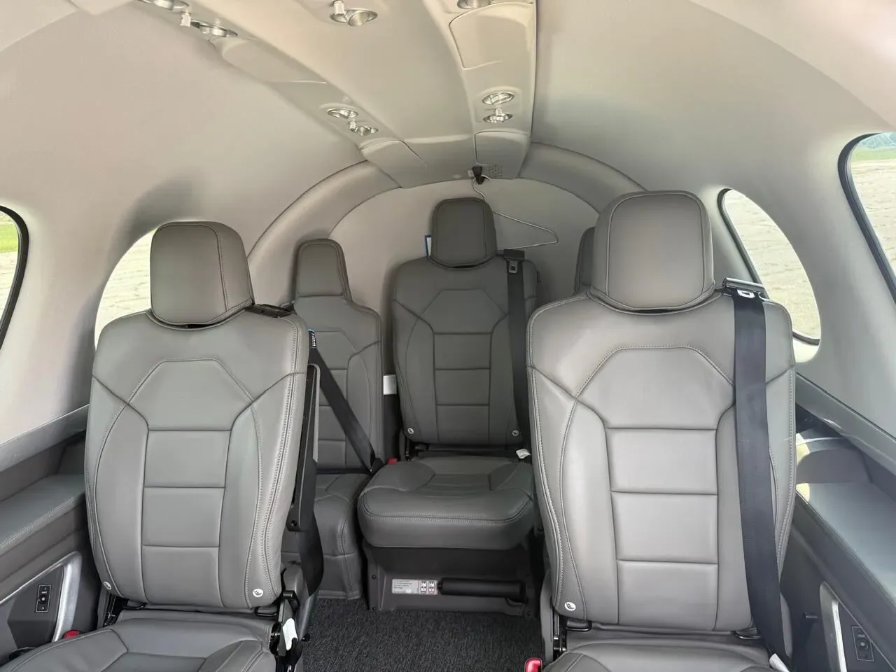The gray leather passenger seats in the cabin of a Cirrus Vision Jet.