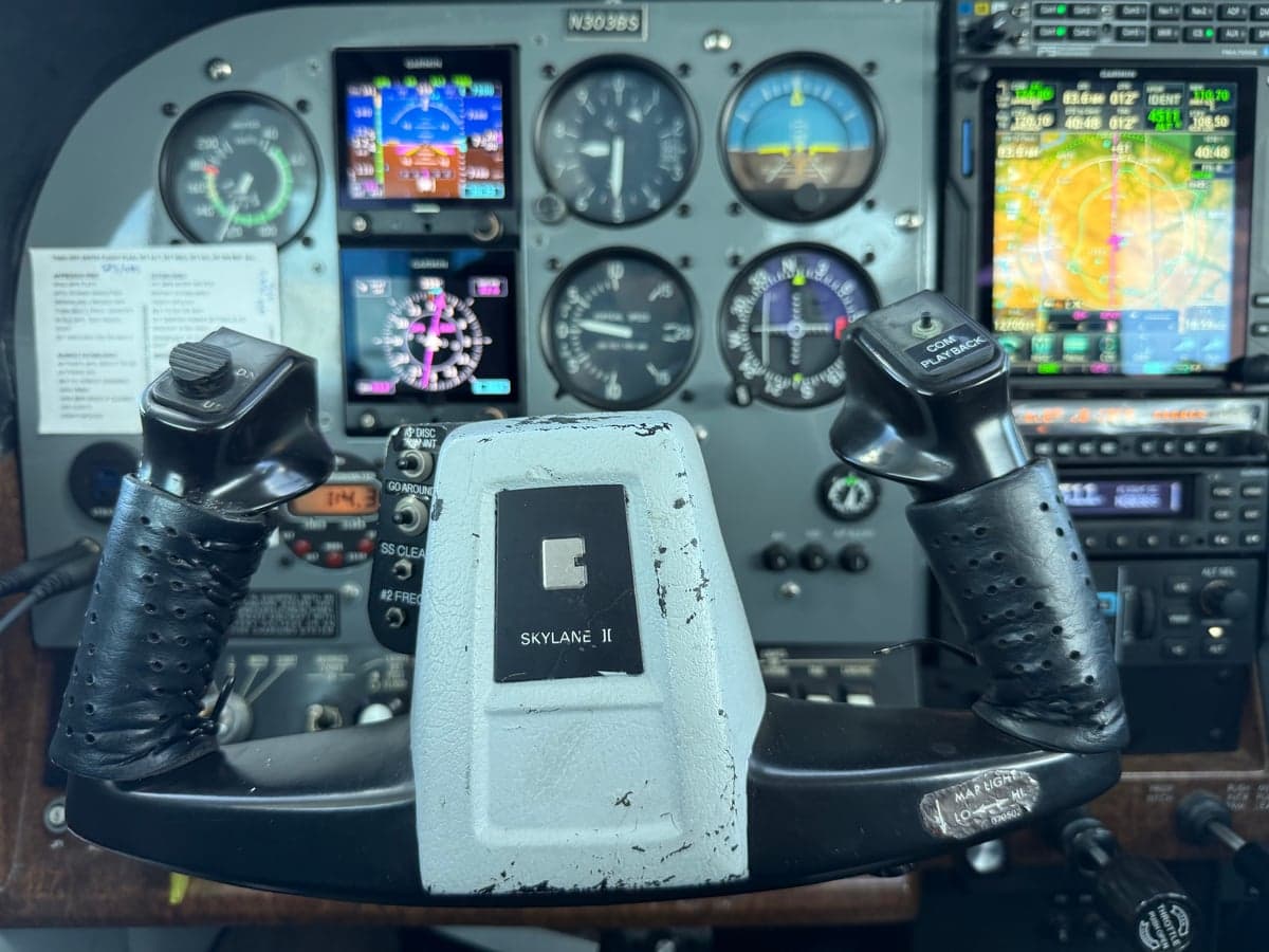 View of the instrument panel and yoke in the cockpit of N303BS.