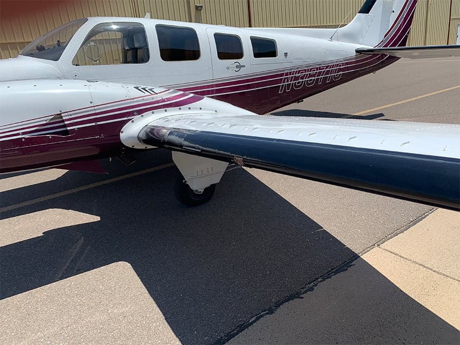 Close-up of the wing and fuselage of the N3871C aircraft.