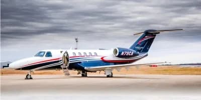 A Cessna Citation CJ3+ parked on the tarmac with the door open.