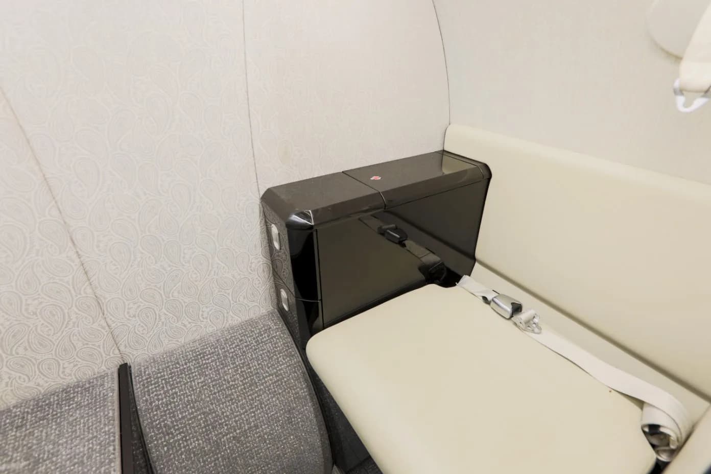 A close-up of the aircraft's interior, showing the seating and side table.