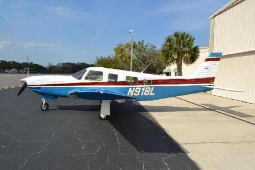 A Piper PA-28-181 Archer II aircraft with registration N918L is parked on the tarmac.
