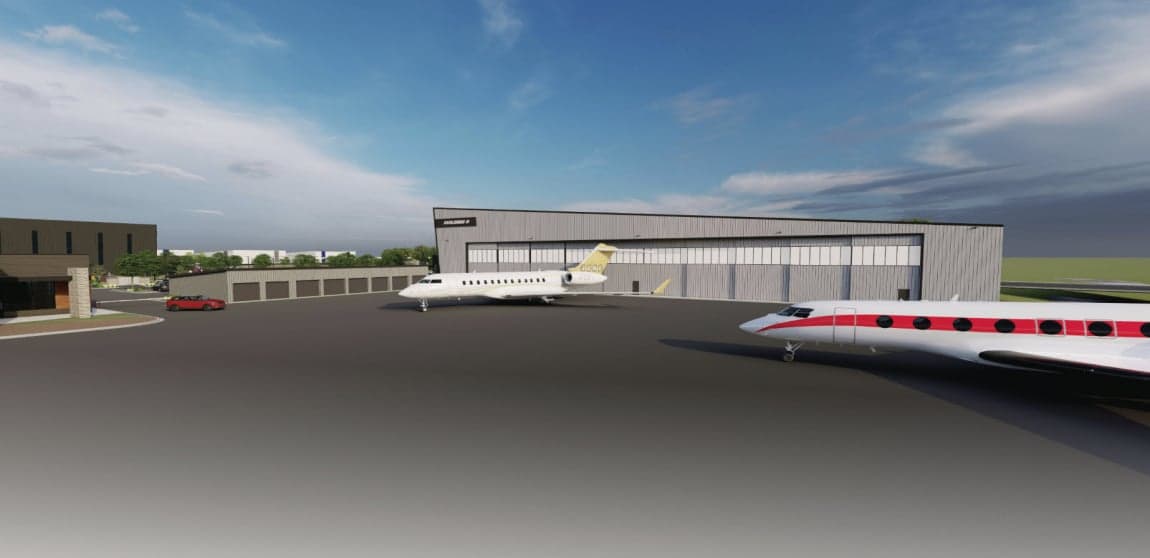 A King Air and other aircraft parked inside a hangar.
