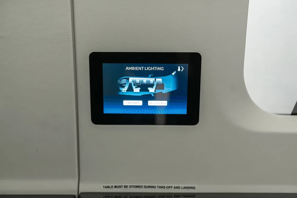 A digital control panel screen displaying ambient lighting options for an aircraft cabin.