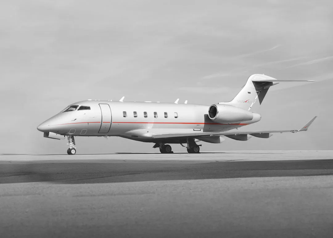 A silver jet sits on the tarmac.