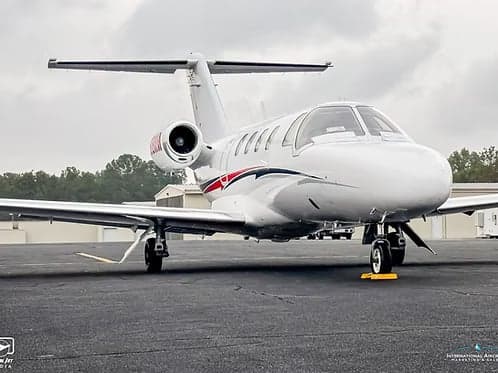 Side view of a Cessna Citation CJ1+ aircraft with registration N608MM on the tarmac.