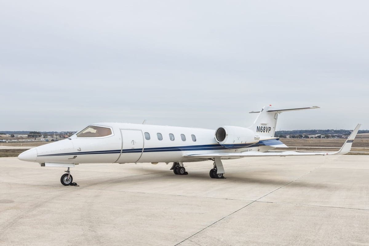 A white Learjet 45XR on the tarmac.