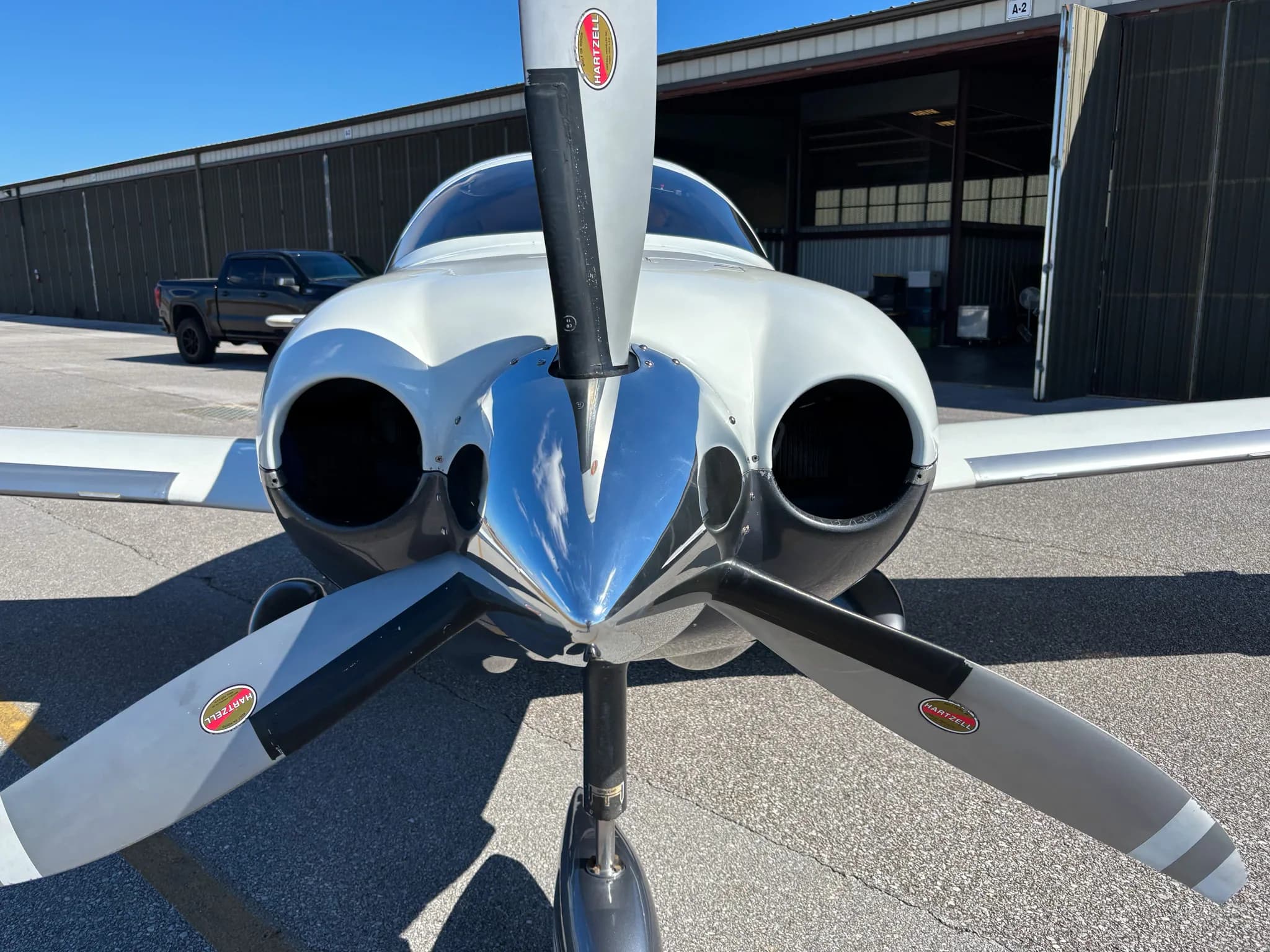 Head-on view of the Lancair Columbia 400 N753MN showing its propeller and engine intakes.
