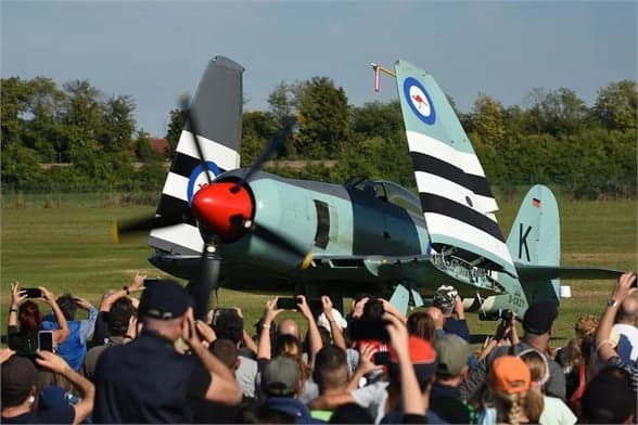 Hawker Sea Fury parked on the tarmac with wings folded.