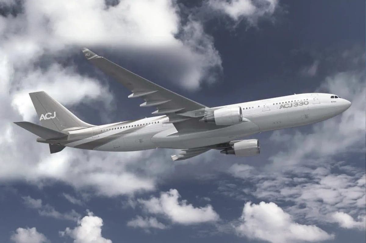 A rendering of an ACJ330 in flight against a cloudy sky.