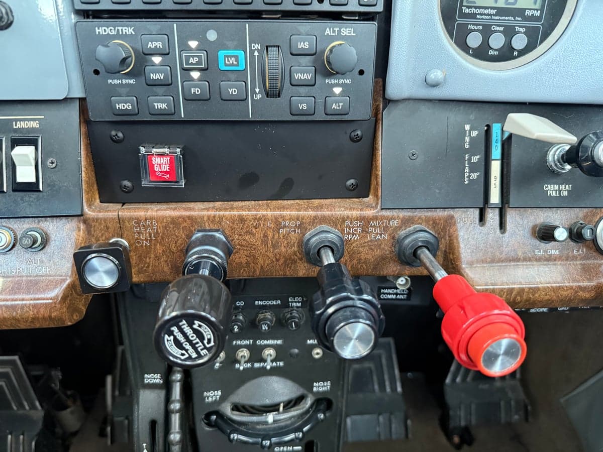 Close-up of the throttle and mixture controls in the cockpit of N303BS.