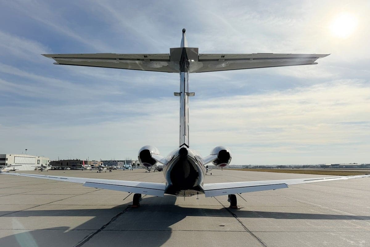 Rear view of a Cessna Citation CJ3+ aircraft on the tarmac, showing the tail and engines.