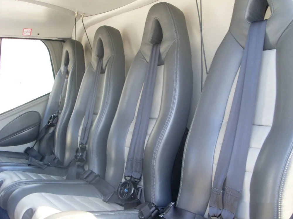 View of the helicopter's interior with gray leather seats.