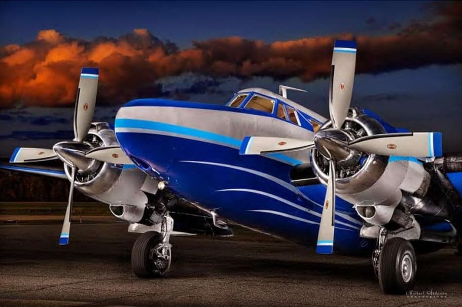 Close-up of the front of a blue and silver Beechcraft Model 18.