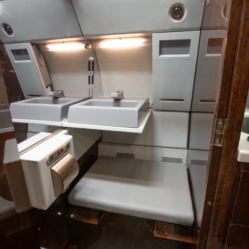 View of the aircraft interior with a sink and storage area.