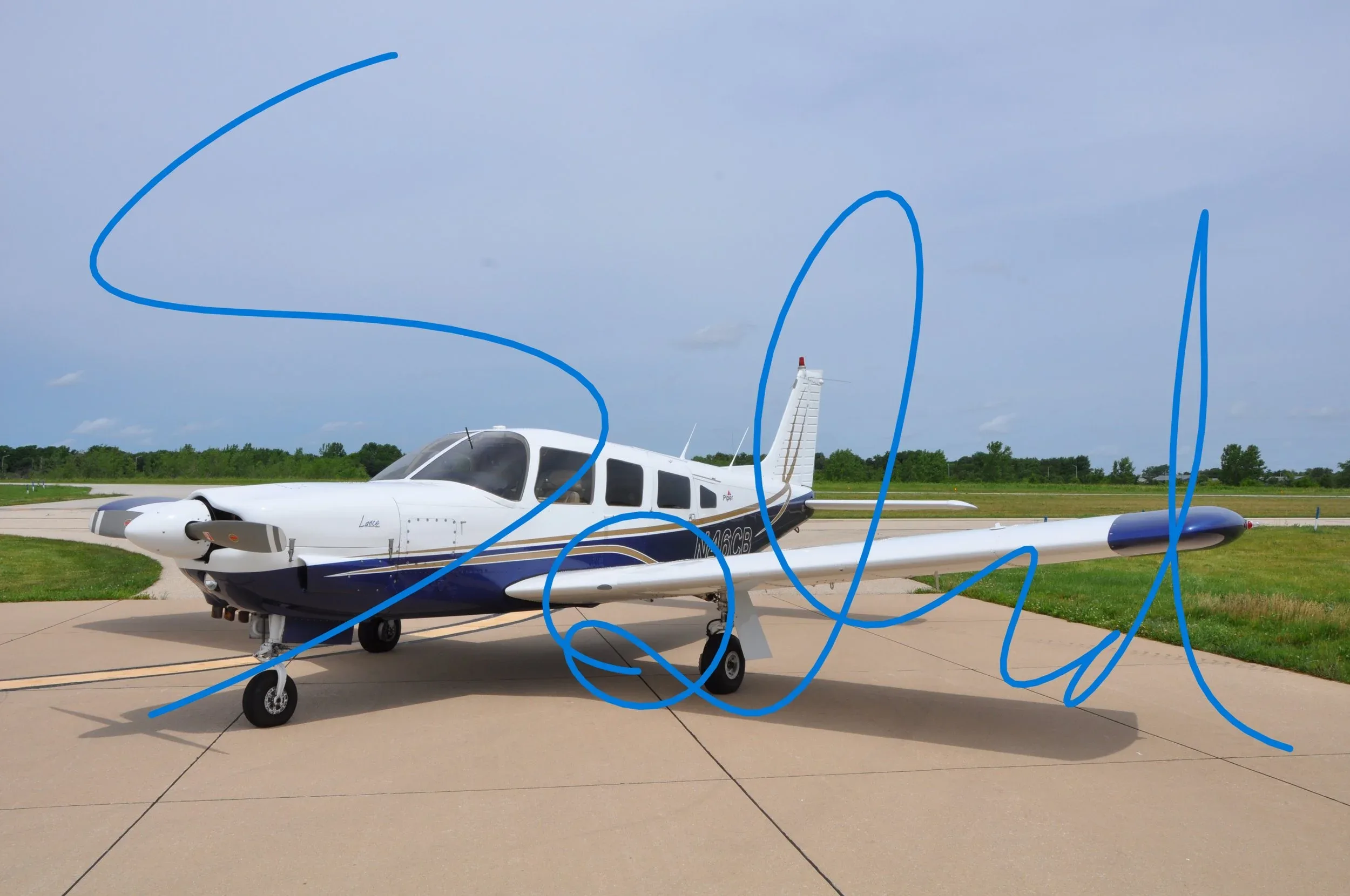A white and blue Piper Lance aircraft with 'Sold' overlaid, parked on an airfield.