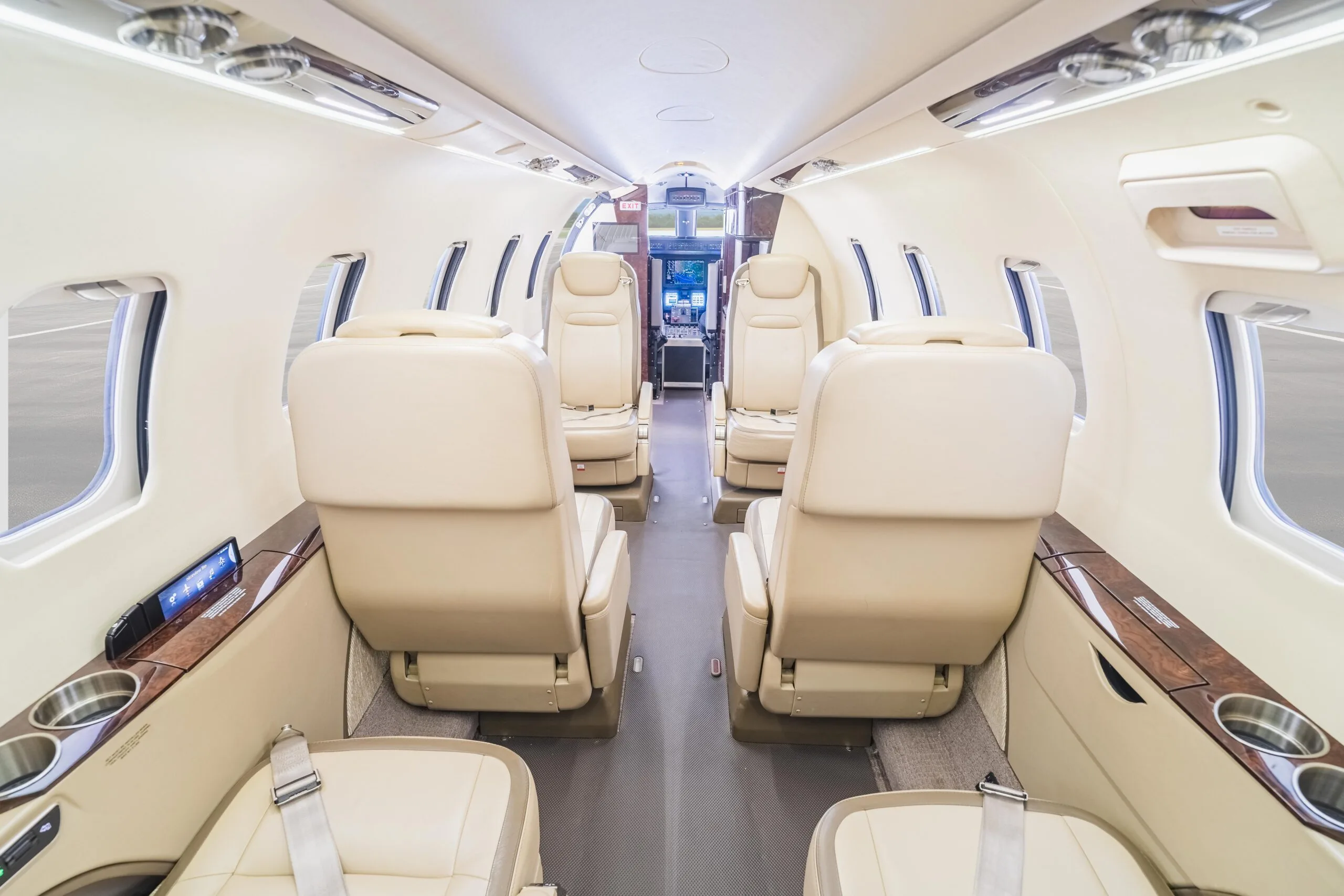 The aircraft's interior is spacious with comfortable seating and a neutral color palette.