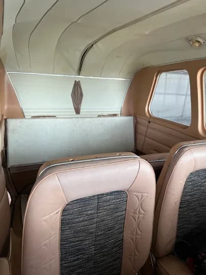 Rear interior view of the aircraft cabin seats.