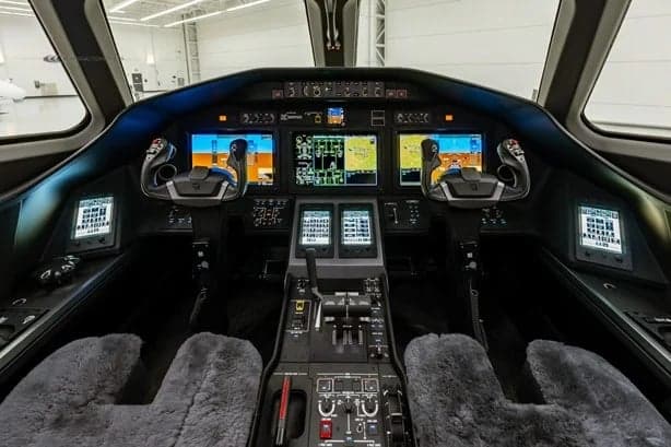The cockpit of the jet features multiple screens and controls.