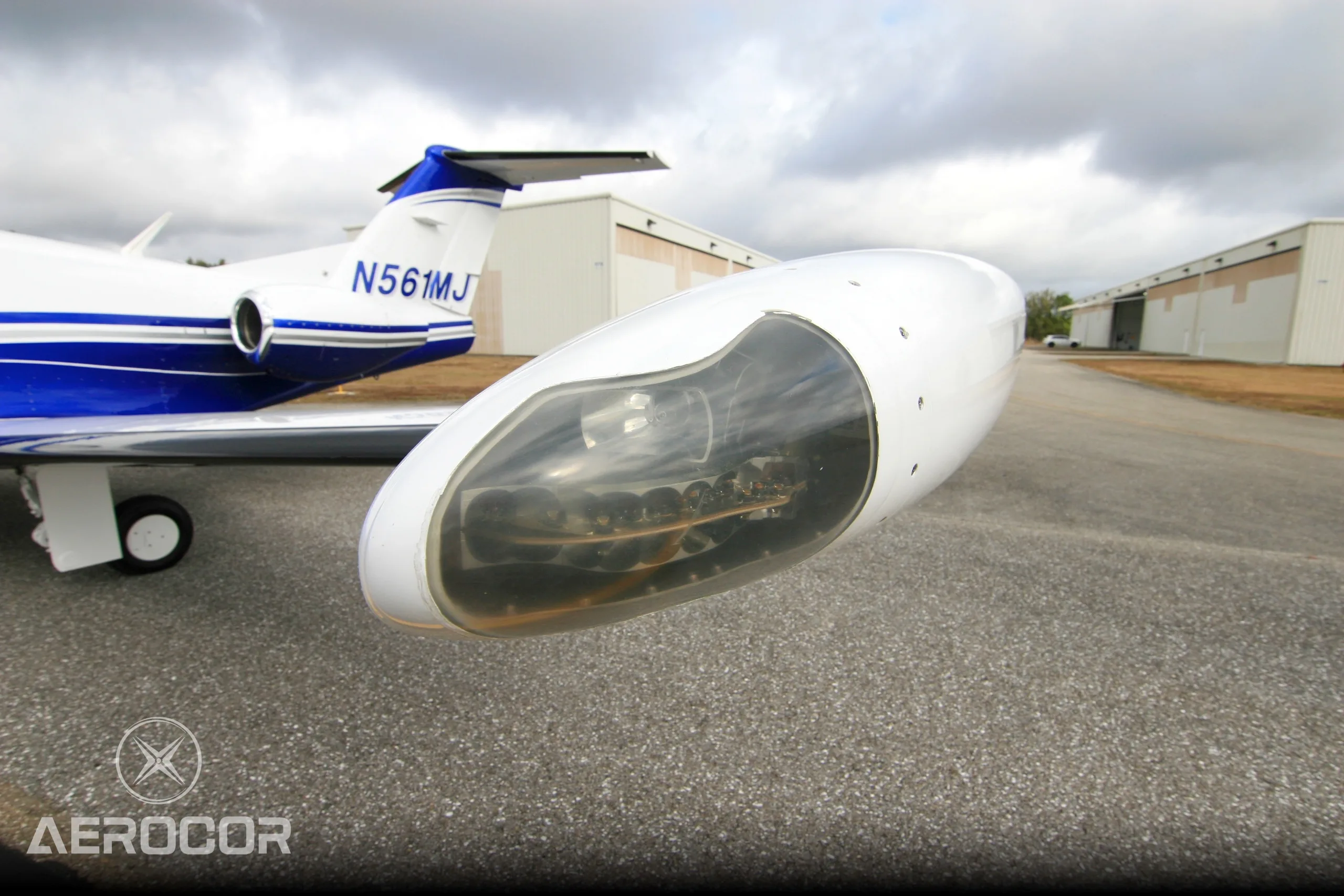 Close-up of the wingtip pod of the Eclipse 500 jet, showing internal components and the aircraft's tail.